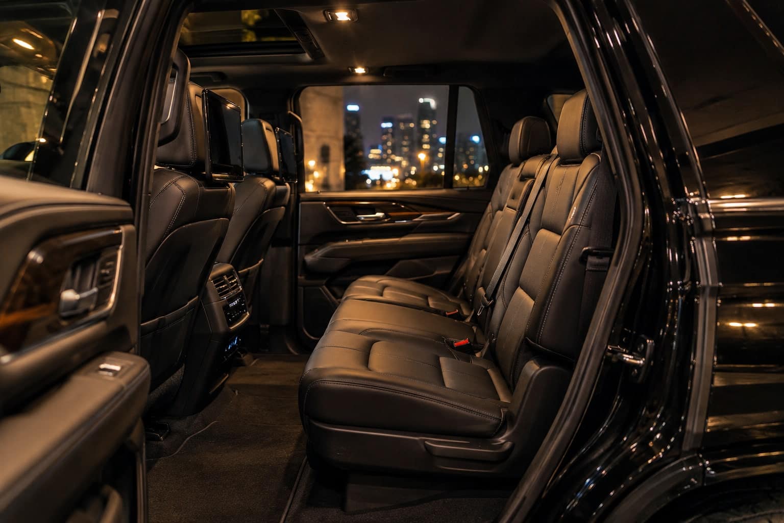 Rear seat of the luxury SUV, seen from the open door.